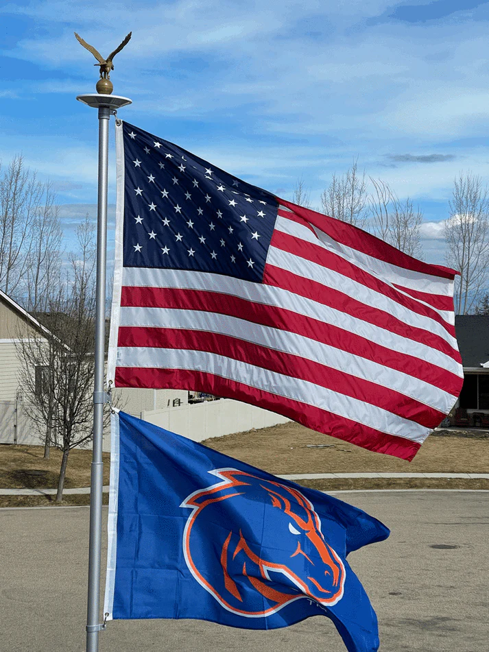 An American flag and a college team flag flying together on a Phoenix flagpole