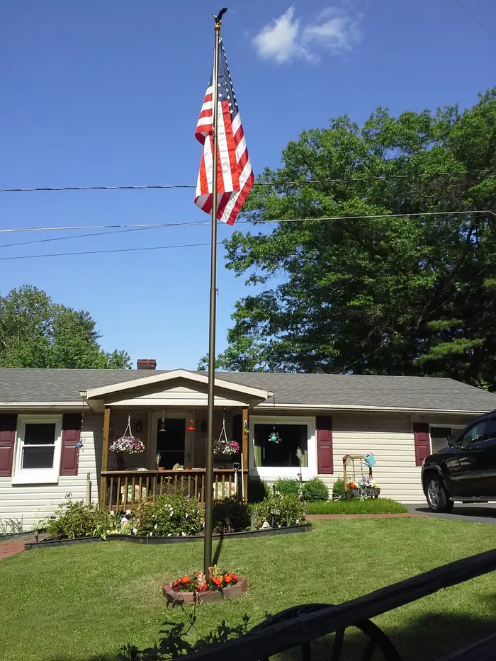 A Phoenix flagpole in front of a one-story ranch home